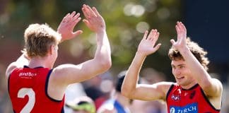 MELBOURNE, AUSTRALIA - FEBRUARY 22: Matthew Jefferson of the Demons celebrates a goal with teammate Jacob van Rooyen during the 2025 AFL match simulation between the North Melbourne Kangaroos and Melbourne Demons at Arden Street on February 22, 2025 in Melbourne, Australia. (Photo by Dylan Burns/AFL Photos via Getty Images)