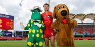 GOLD COAST, AUSTRALIA - FEBRUARY 28: Lachie Weller of the Suns, Dorothy the Dinosaur and Wags the Dog pose for a photo during the announcement of The Wiggles performance at the Gold Coast Sun's AFL Opening Round match, at People First Stadium on February 28, 2025 in Gold Coast, Australia. (Photo by Russell Freeman/AFL Photos via Getty Images)