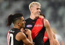 GEELONG, AUSTRALIA - FEBRUARY 25: Nate Caddy of the Bombers is congratulated by Isaac Kako of the Bombers after kicking a goal during the 2025 AAMI AFL Community Series match between Geelong Cats and Essendon Bombers at GMHBA Stadium on February 25, 2025 in Geelong, Australia. (Photo by Quinn Rooney/Getty Images)