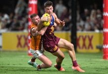 IPSWICH, AUSTRALIA - FEBRUARY 27: Josh Dunkley of the Lions is tackled during the 2025 AAMI AFL Community Series match between Brisbane Lions and Adelaide Crows at Brighton Homes Arena on February 27, 2025 in Ipswich, Australia. (Photo by Bradley Kanaris/Getty Images)