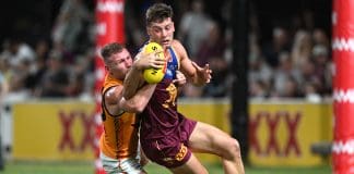 IPSWICH, AUSTRALIA - FEBRUARY 27: Josh Dunkley of the Lions is tackled during the 2025 AAMI AFL Community Series match between Brisbane Lions and Adelaide Crows at Brighton Homes Arena on February 27, 2025 in Ipswich, Australia. (Photo by Bradley Kanaris/Getty Images)